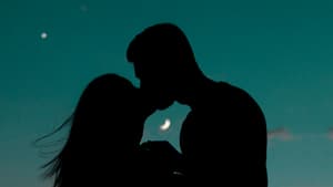 Pärchen küsst sich vor Mondhimmel