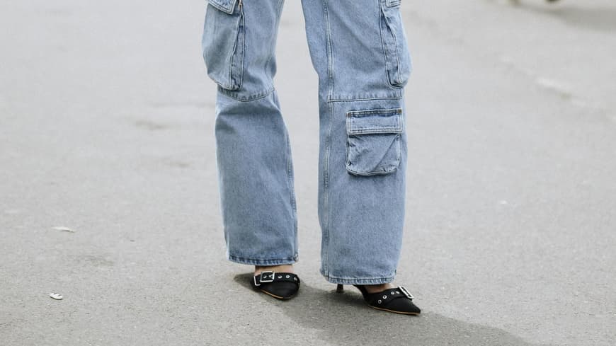 Frau mit einer weiten Jeanshose und spitzen Heels