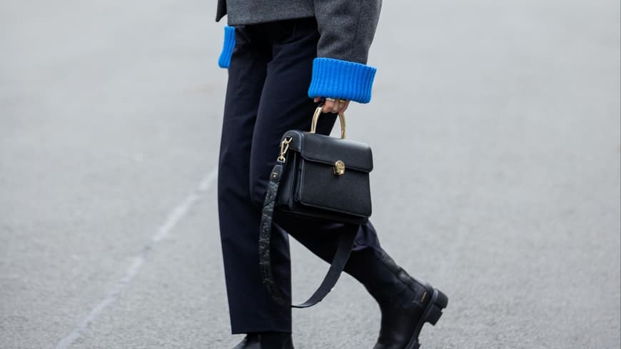 Aline Kaplan trägt schwarze Aigner Tasche schwarze Boots und graue Wolljacke
