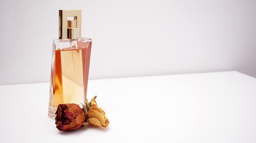 Parfum mit einem getrockneten Rosenkopf