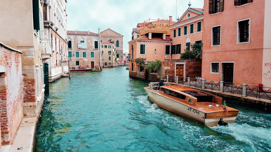 Ein Kanal in Venedig mit bunten Häusern und einem Boot.