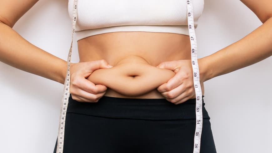 Eine Frau hält sich den Bauch