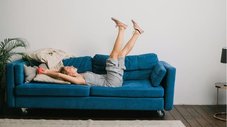 Frau liegt auf einer Couch