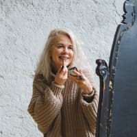 Frau trägt Lippenstift auf