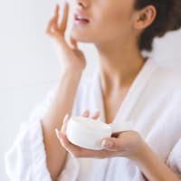 Frau hält Gesichtscreme