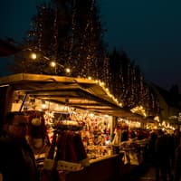 Der Besuch auf dem Weihnachtsmarkt gehört für viele dazu. Weihnachtsmarkt mit beleuchteten Geschäften