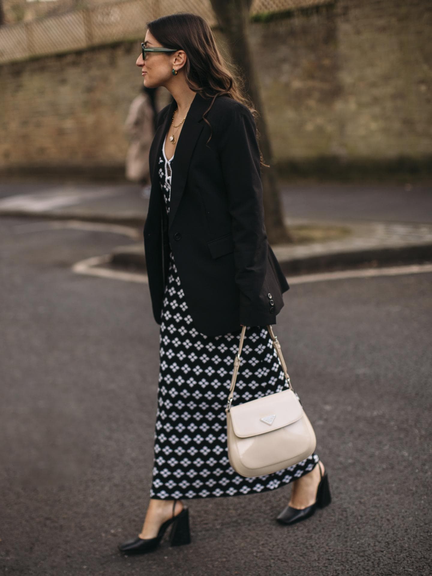 Eine Frau trägt ein langes Kleid und einen Blazer