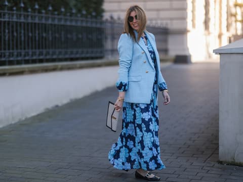 Frau in hellblauem Kleid mit Blazer