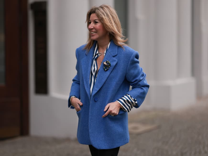 Frau in Blazer mit Brosche